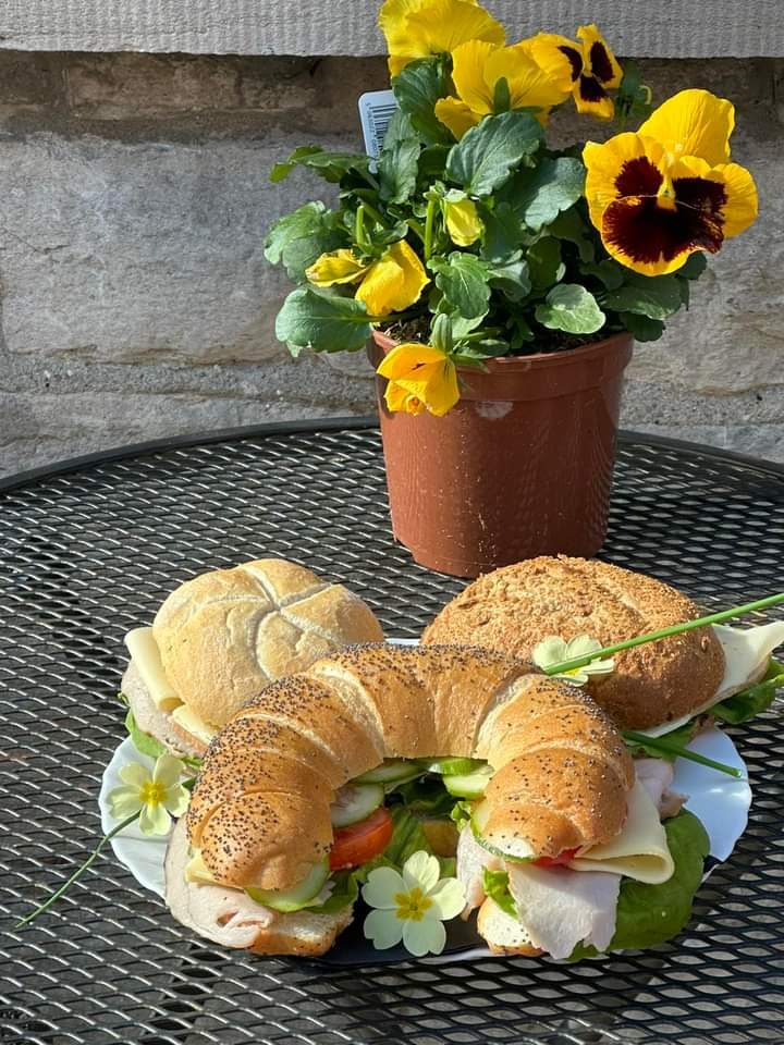 Croissants with salad leaves and pansies